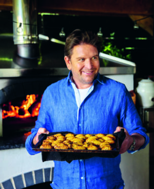 James Martin holds a baking tray.