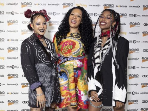 Mobo founder Kanya King (centre) with Nova Twins attend the Mobo Awards 2022 nominations at Cafe KOKO, in north west London (Belinda Jiao/PA)