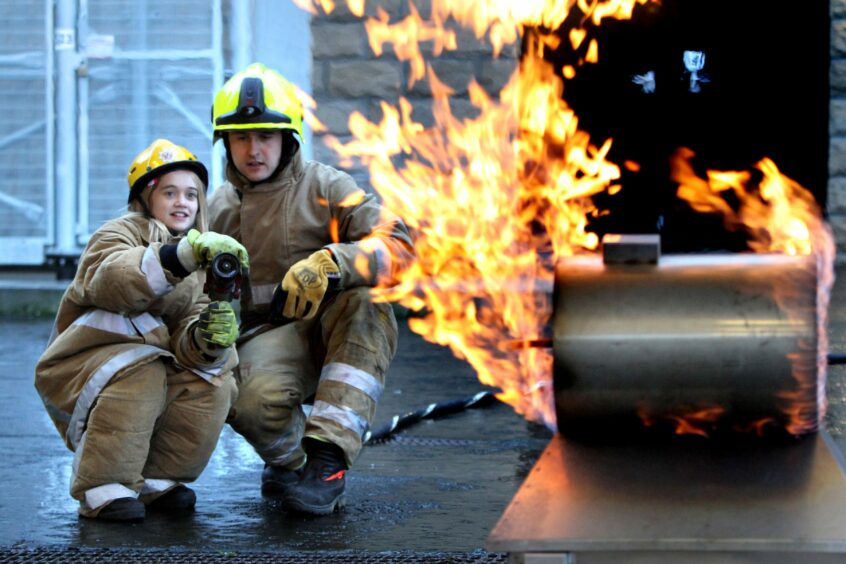 Melissa MacLeerie helping to put out a fire