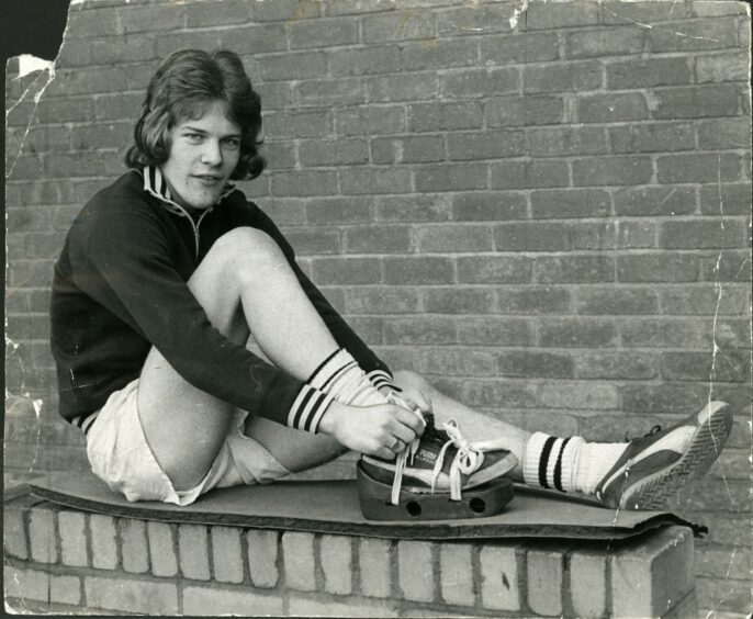 Andy Gray ties the laces of some protective footwear in February 1974, following an operation. He would, of course, fully recover and go on to a stellar career that also saw him net seven times in 20 appearances for Scotland. Image: DC Thomson.