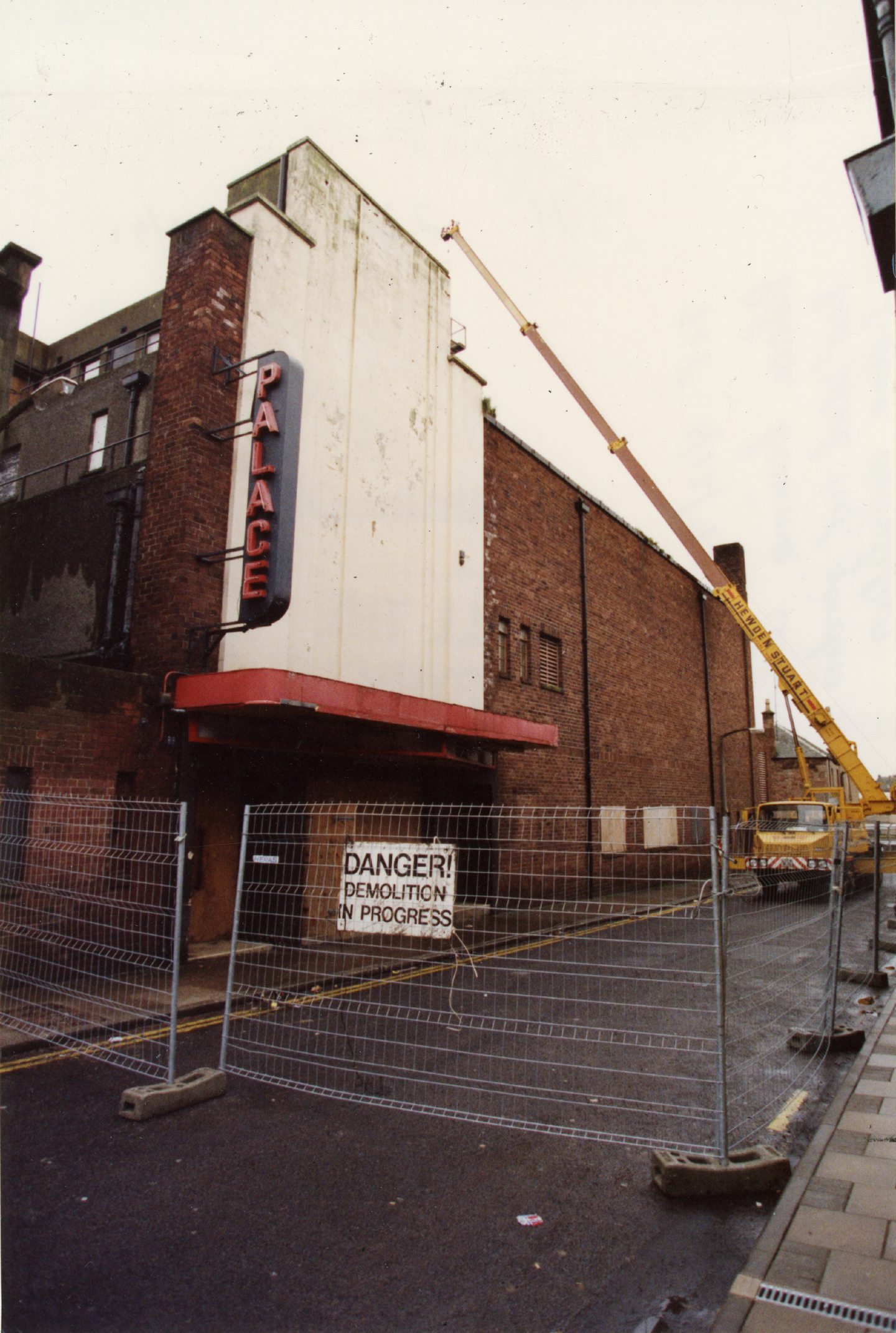 A sign on some fencing outside the old Palace Cinema warns of demolition works. 