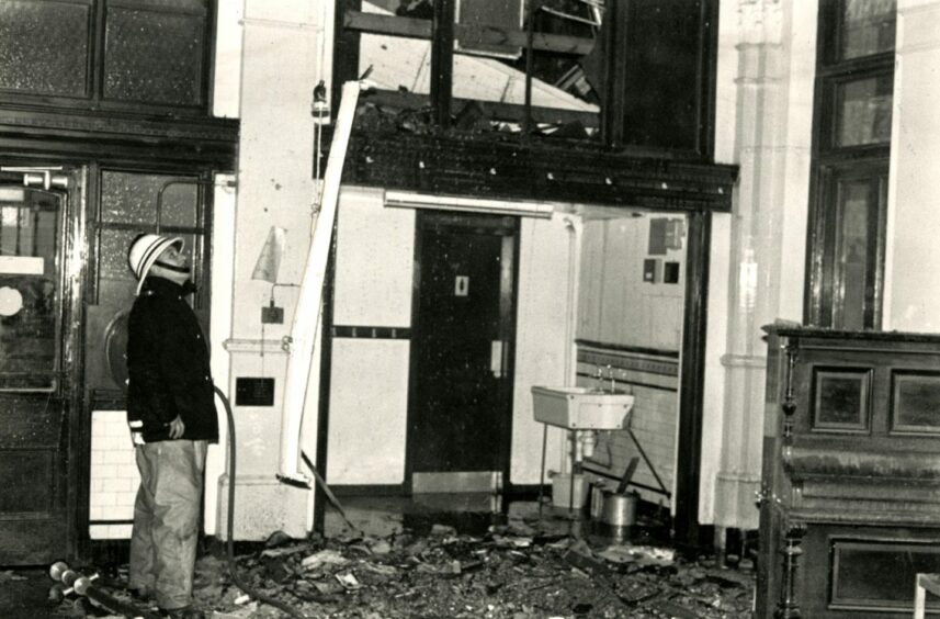 A fireman surveys the school's damaged interior. November 4 1987. Image: DC Thomson.