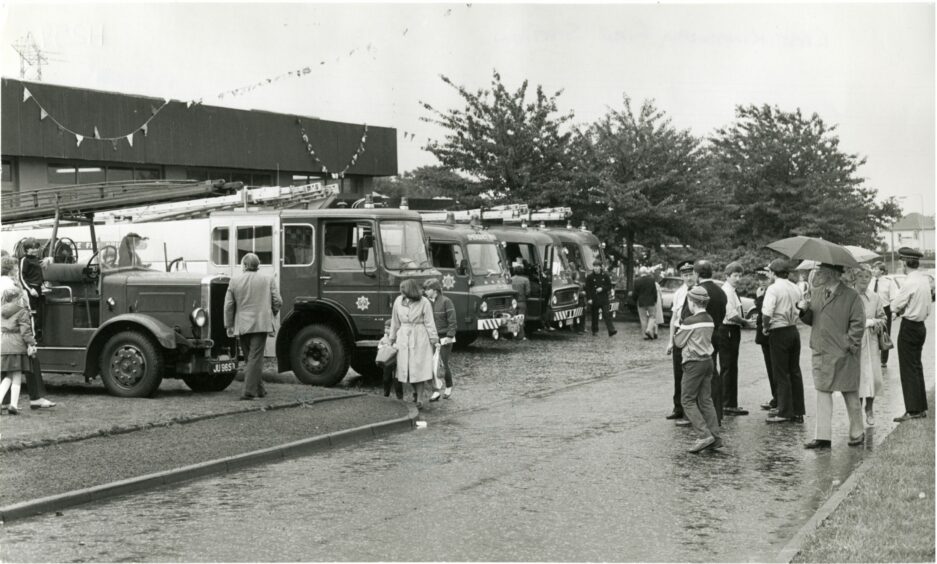 Visitors in the rain view the fire engines at the Kingsway East open day. September 1984.