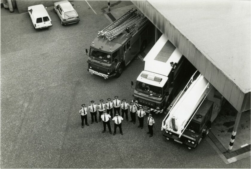 Tayside Fire Service crew next to three fire engines at Kingsway East Fire Station, Dundee. 1989