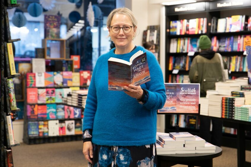 Elisabeth Gifford shows off her book at Waterstone's in Dundee before a talk. Image: Kim Cessford/DC Thomson.