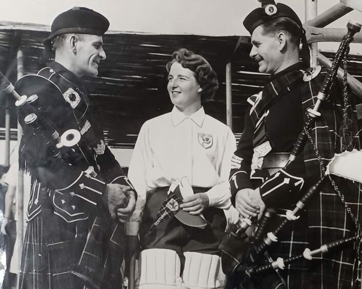 Mary Laskie in Northern Rhodesia in 1958 with pipers Kenny, left, and John McKenzie of Campbelltown.