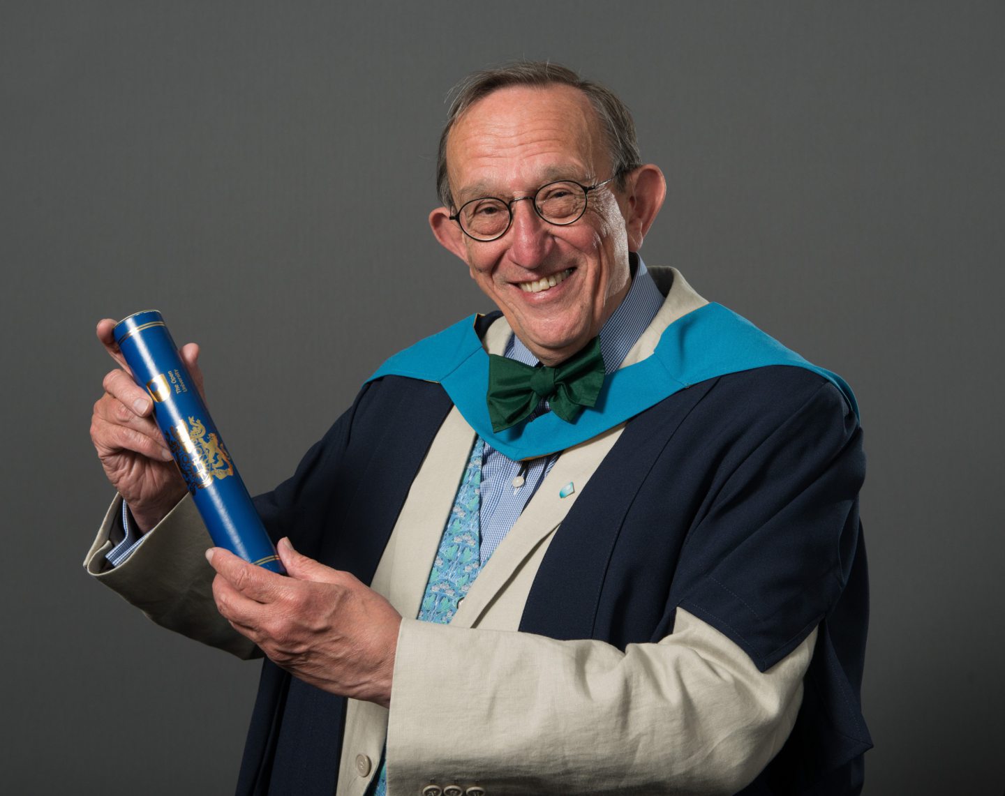 Simon Weller pictured in 2014 with his Open University degree, which completed 40 years of extra study with the institution. Image: Supplied