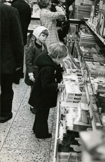Youngsters looking at what the shops have to offer in 1970.