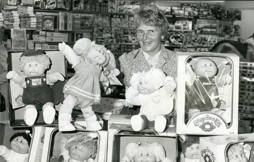 Isabel Duncan, who ran the Toymaster shop, with the Cabbage Patch Kids in October 1984. Image: DC Thomson.