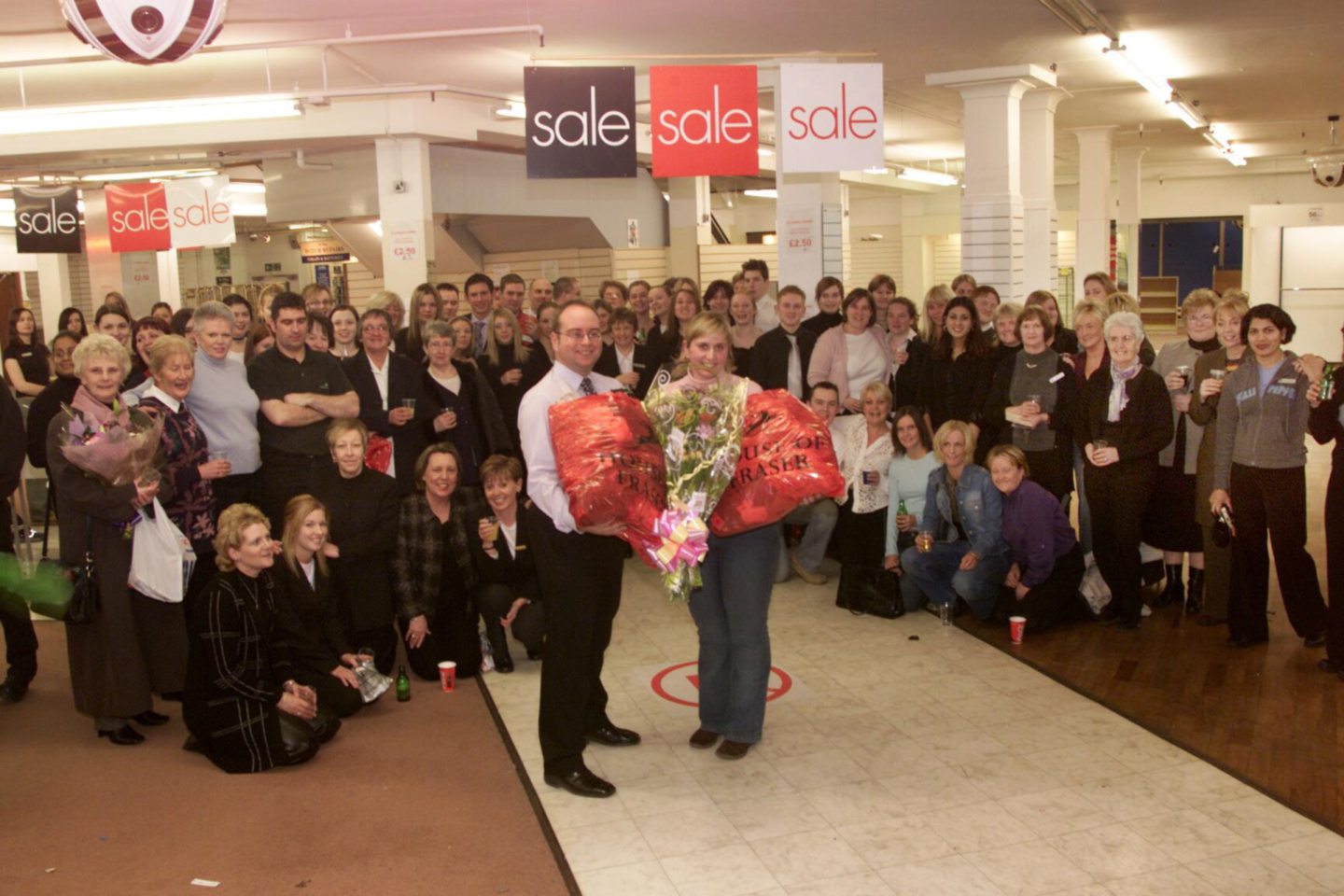 Arnotts store manager Craig Stevenson presents a bouquet to last customer Lynsey Webster