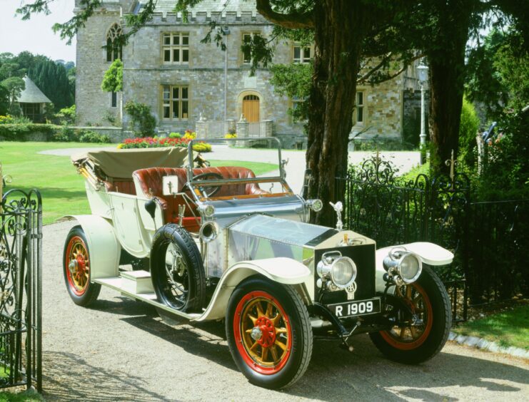 Lord Montagu's 1909 Rolls-Royce silver Ghost in driveway of Palace House, Beaulieu. Image: National Motor Museum/Shutterstock.