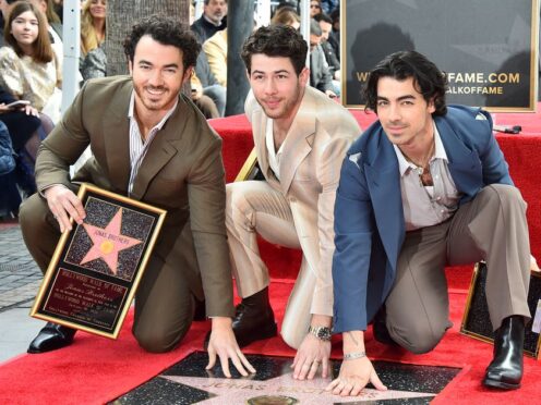 Kevin Jonas, from left, Nick Jonas, and Joe Jonas pose at a ceremony honoring them with a star on the Hollywood Walk of Fame, Monday, Jan. 30, 2023, in Los Angeles. (Photo by Jordan Strauss/Invision/AP)