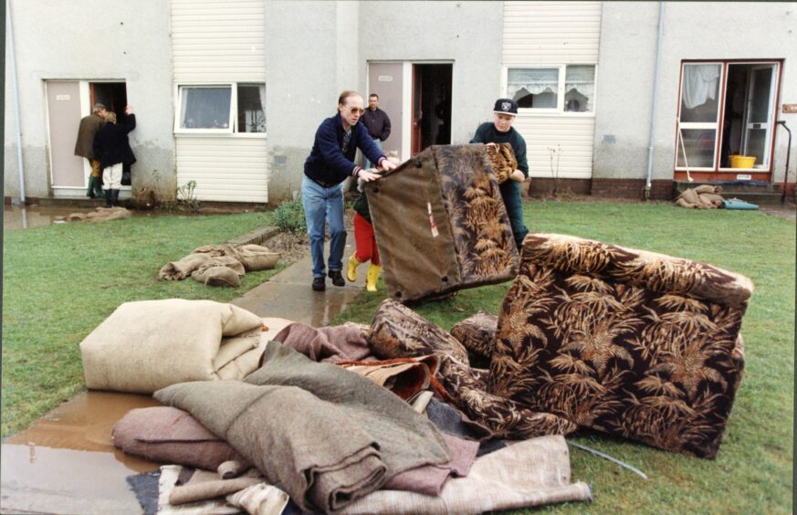 Ruined furniture being removed from the home of residents in Perth. Image: DC Thomson.