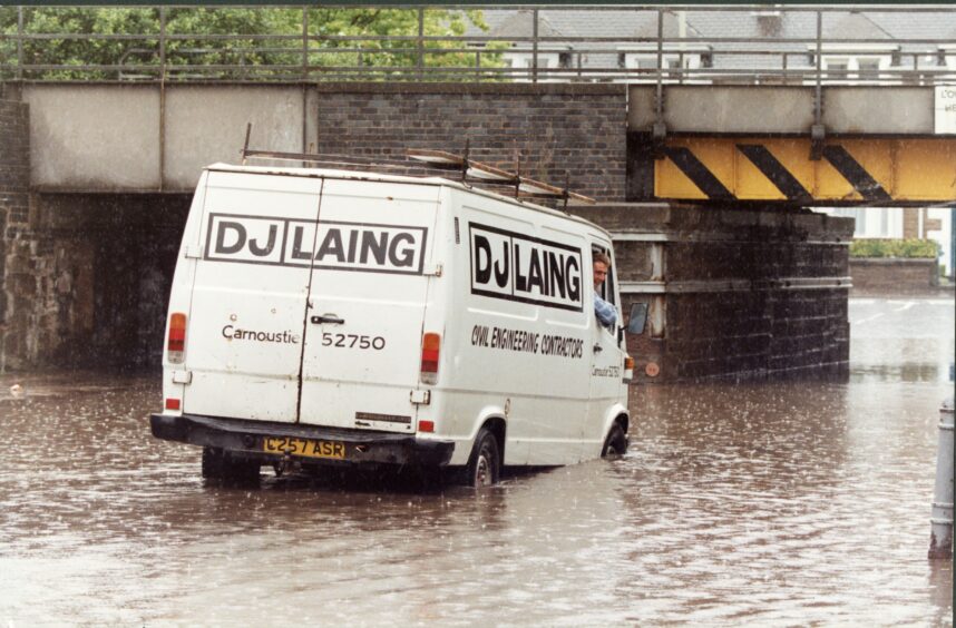 A van looks to be in trouble below the railway bridge at Broughty Ferry. Image: DC Thomson.