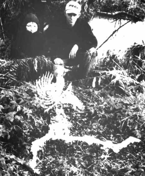 A black and white image of Kyle Farquhar and Derek Ohldag with a sheep allegedly slaughtered by the beast of Bennachie in 1996 at Pitcaple
