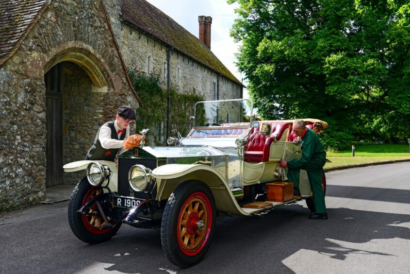 Workshop volunteer Phil Hibbard, right, and front of house employee Dan Fearnley polishing the 1909 Rolls-Royce at the National Motor Museum, Beaulieu, ahead of an event in July 2022. Image: Shutterstock/David Clarke/Solent.