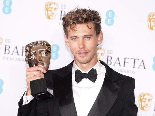 Austin Butler poses with the award for leading actor (Ian West/PA)