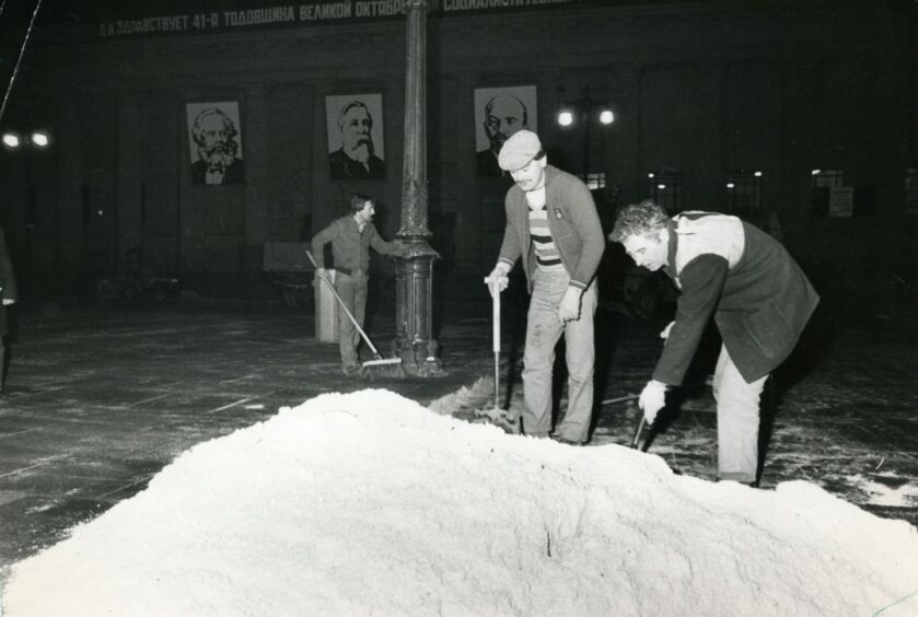 Tayside Region staff sweeping salt to create the look of snow at the City Square. Image: DC Thomson.