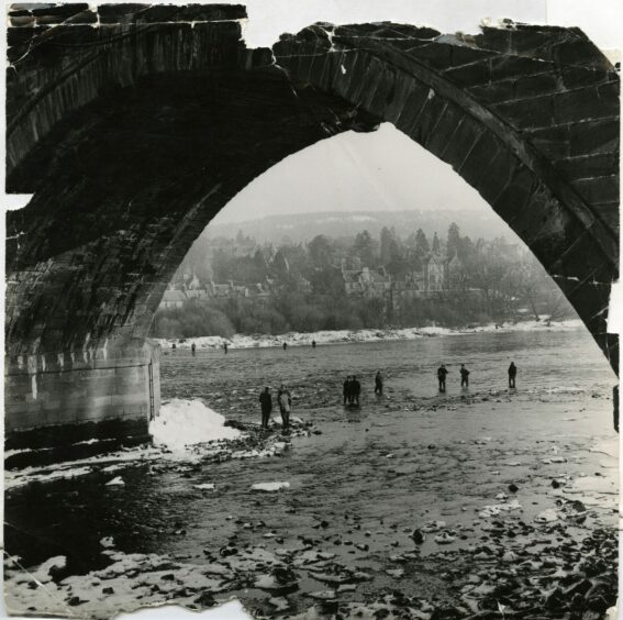 Anglers fishing under the bridge at Perth in February 1963