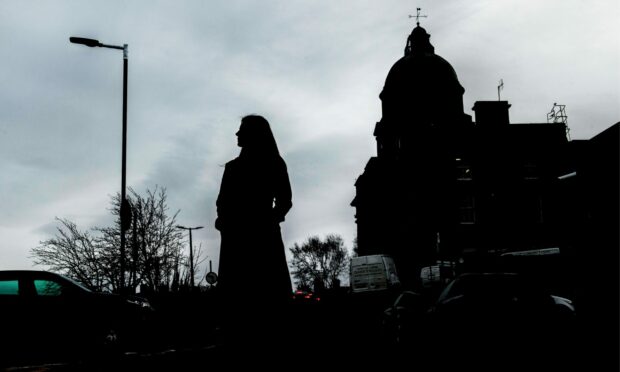 A silhouette of a woman in front of Dr Gray's.  