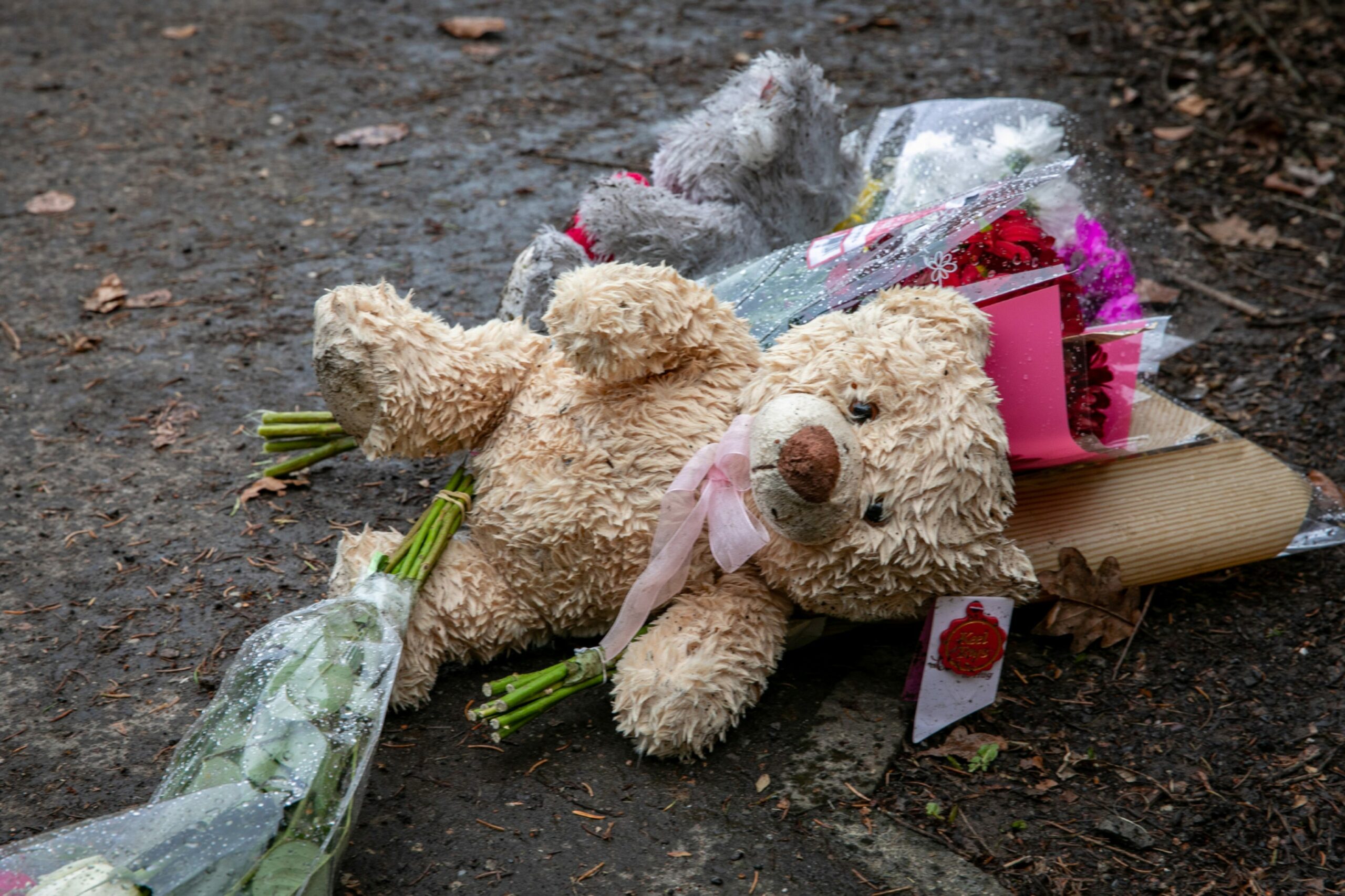 Floral tributes and teddy bears left at the street entrances of Troon Avenue, Dundee.
