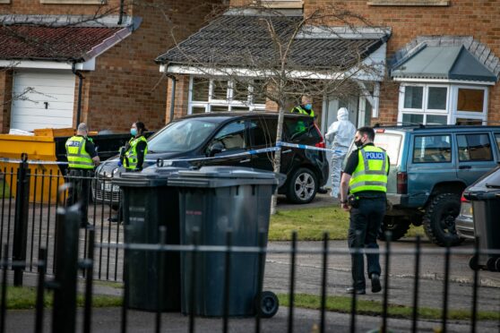 Forensic officers outside Innis's home as part of a murder investigation
