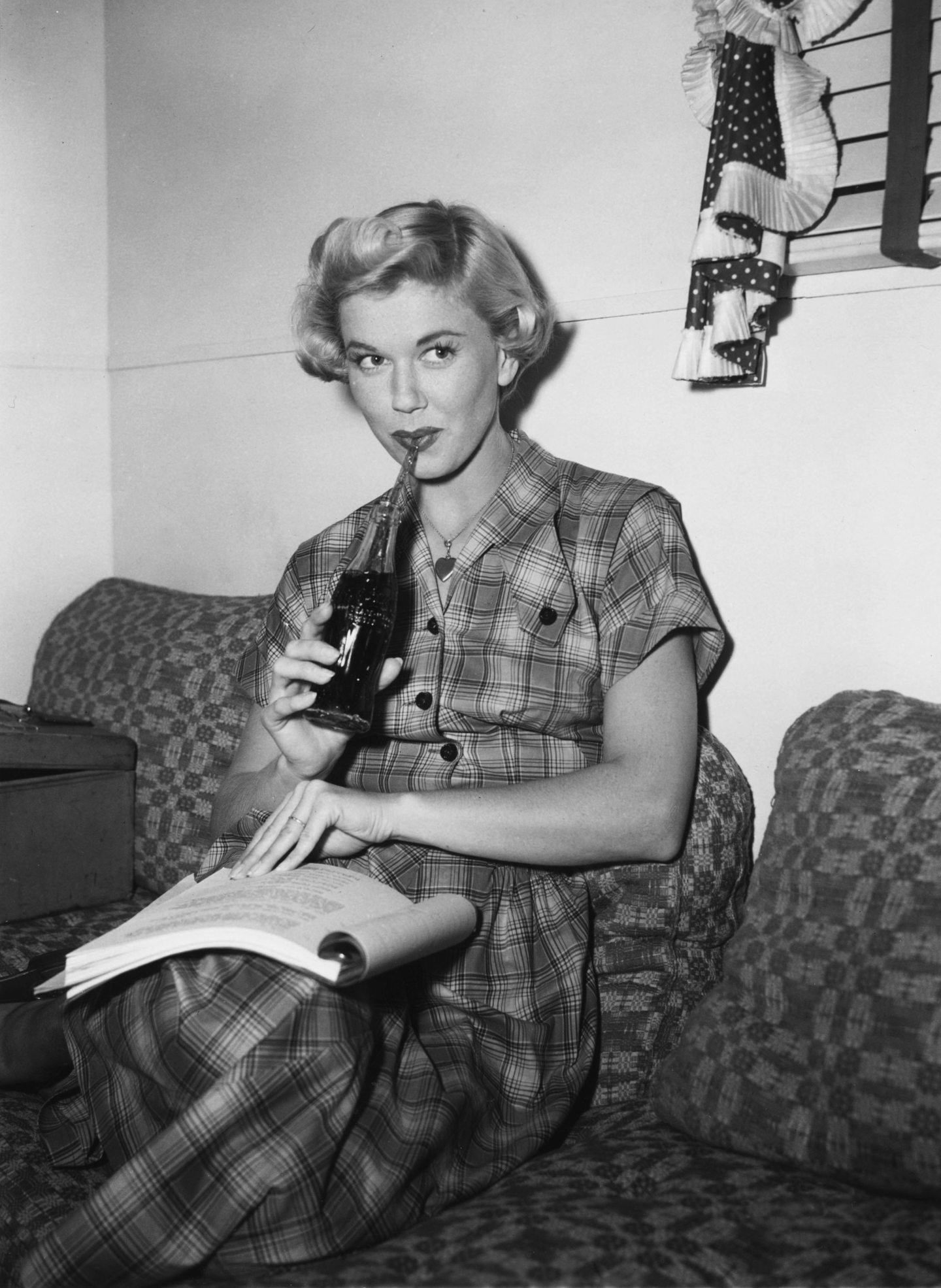 Actress Doris Day pictured drinking Coca-Cola on the set of By The Light Of The Silvery Moon in 1953. Image: Warner Bros/Kobal/Shutterstock.