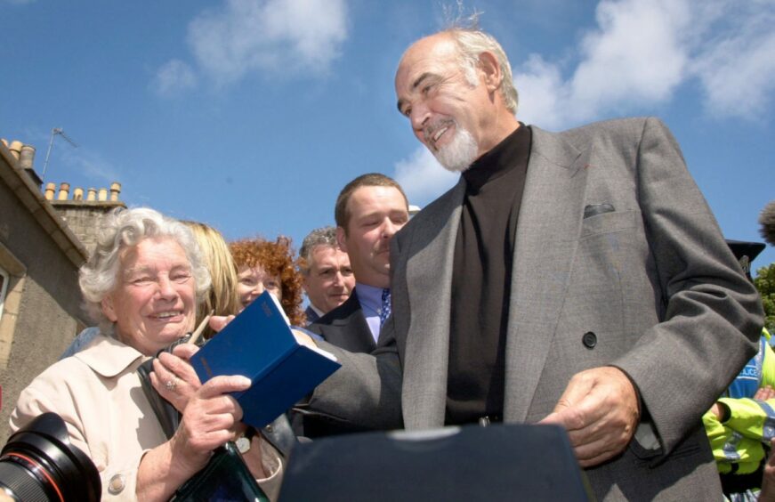 Sir Sean Connery signs autographs for fans after opening the Byre Theatre in St Andrews. Image: PA.