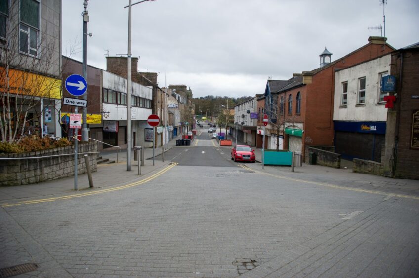 Little was happening on this deserted High Street in Lochee on March 25 2020. Image: Kim Cessford/DC Thomson.