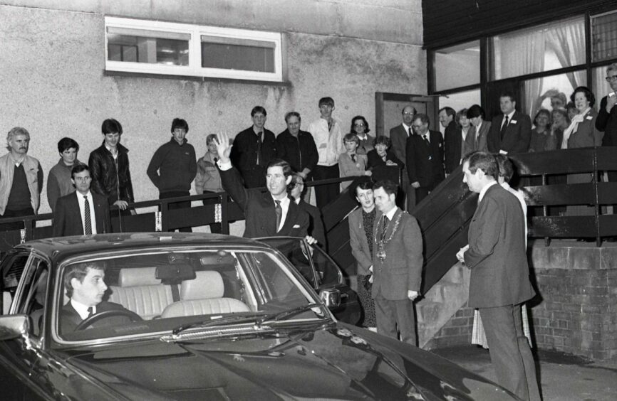 Charles waves to the crowd that stayed behind to see him leaving Orleans Place. Image: DC Thomson.