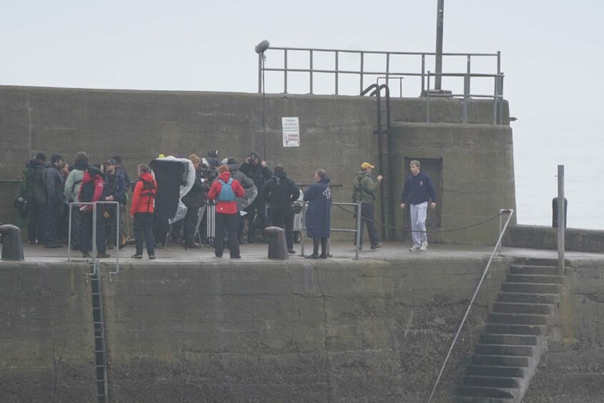 The Crown cast and crew filming on the pier in St Andrews.