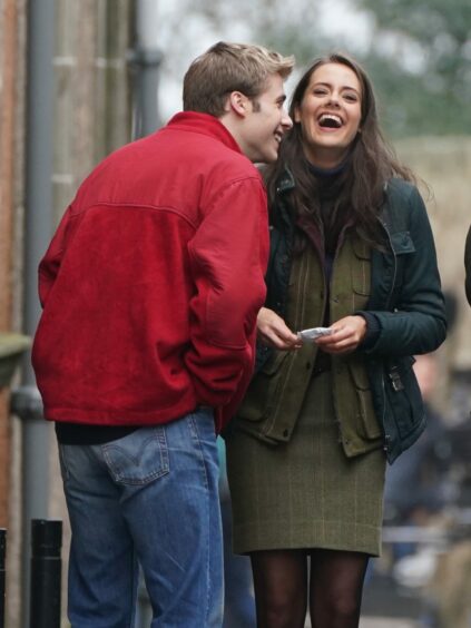 Kate and William, played by actors Meg Bellamy and Ed McVey, share a joke on set during the filming of season six of Netflix show The Crown.