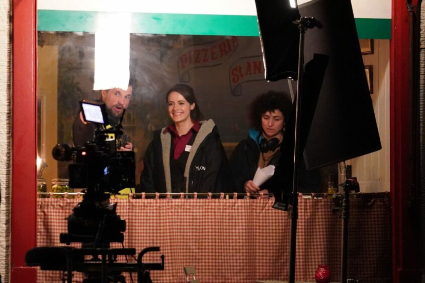 The Crown cast and crew filming at the Pizzeria in St Andrews, Scotland.