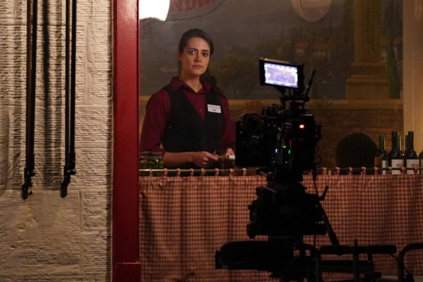 Kate Middleton, played by Meg Bellamy, working in the Pizzeria in St Andrews in season six of Netflix series The Crown.