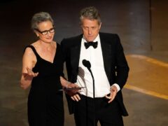Andie MacDowell, left, and Hugh Grant present the award for best production design at the Oscars on Sunday, March 12, 2023, at the Dolby Theatre in Los Angeles (Chris Pizzello/AP)