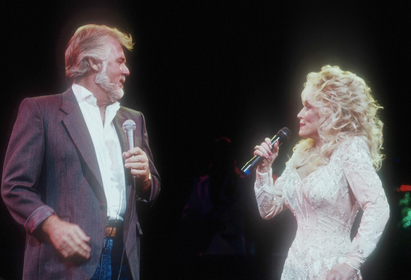Kenny Rogers and Dolly Parton performing on stage in the 1980s.
