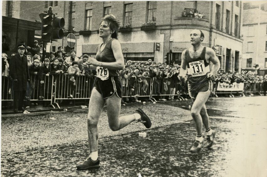 Marjorie Thom running past the Thomas Cook building during the Dundee Marathon