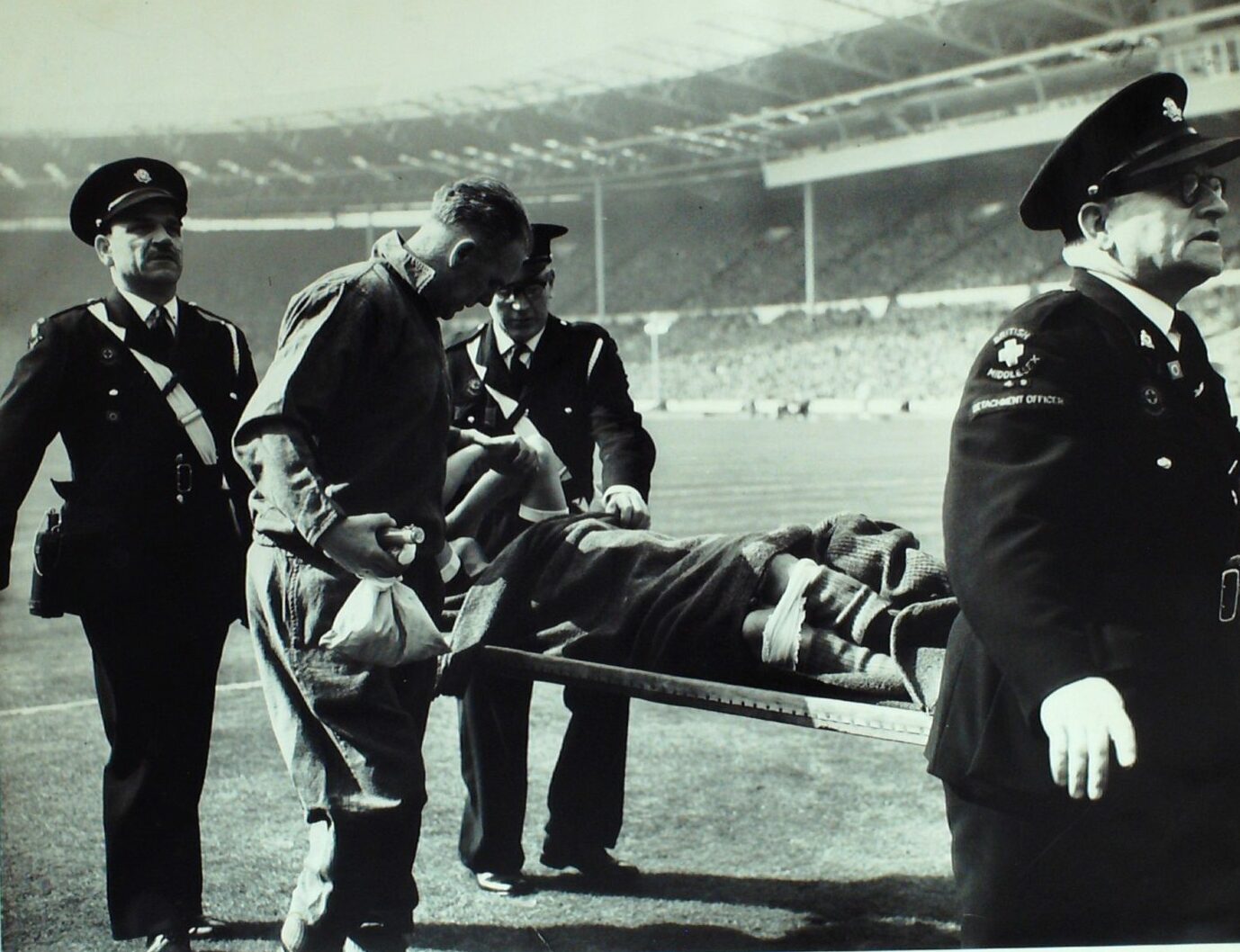 Caldow being carried off on a stretcher following the collision in the Auld Enemy clash in 1963.