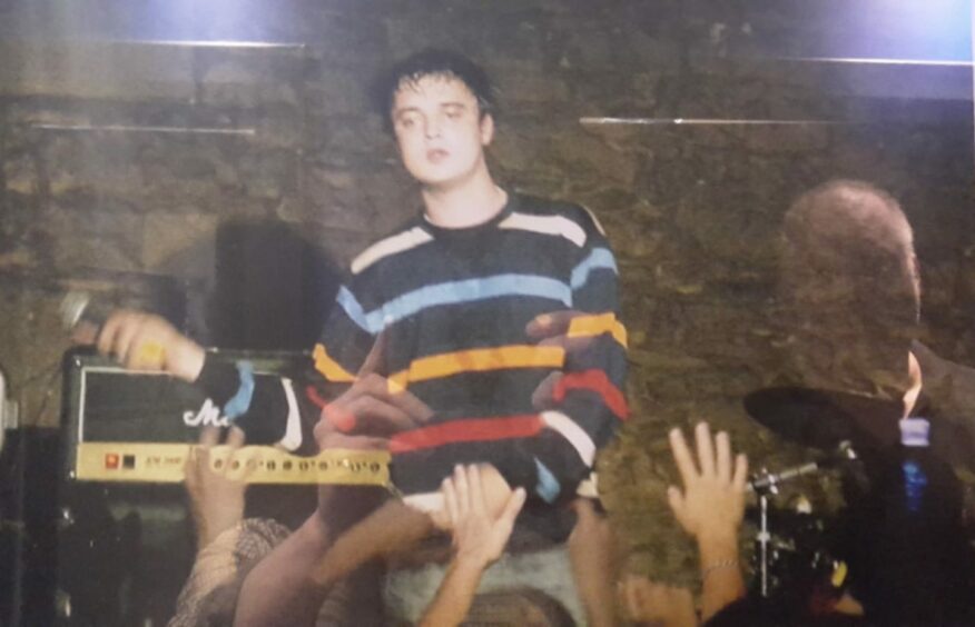Pete Doherty on stage at Fat Sam's after being patched up by Colin.
