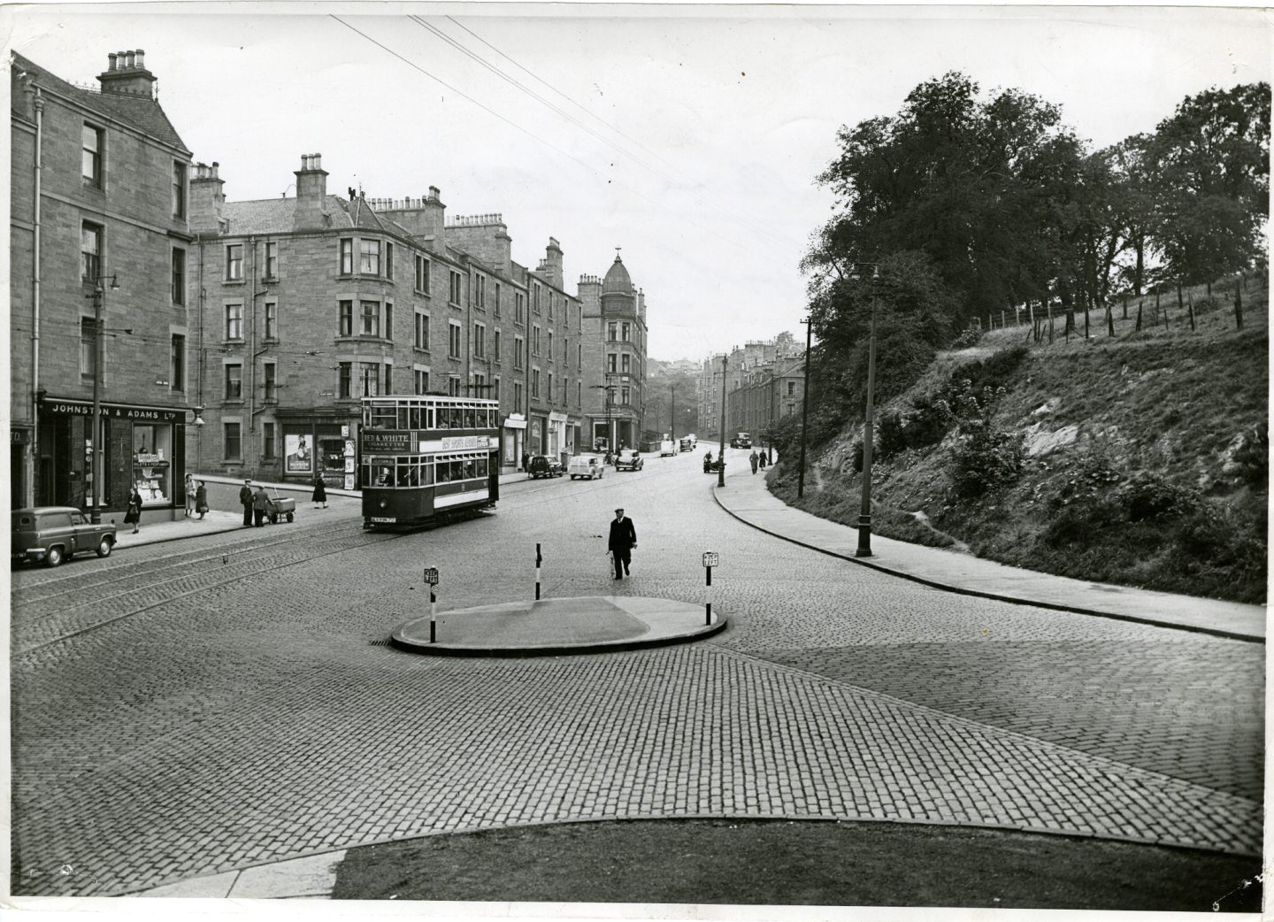 Photograph showing a view of Lochee Road with a tram in view in September 1956.