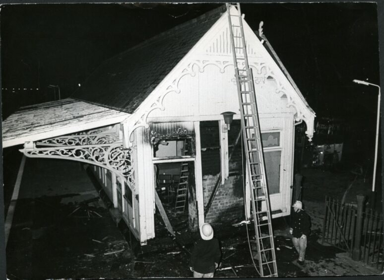 Firefighters inspecting damage to the exterior of Monifieth Railway Station in April 1986. Image: DC Thomson.