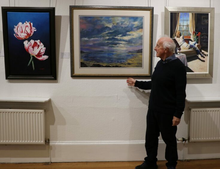 Menzieshill Road-based painter John Stoa is pictured at one of the society's displays.