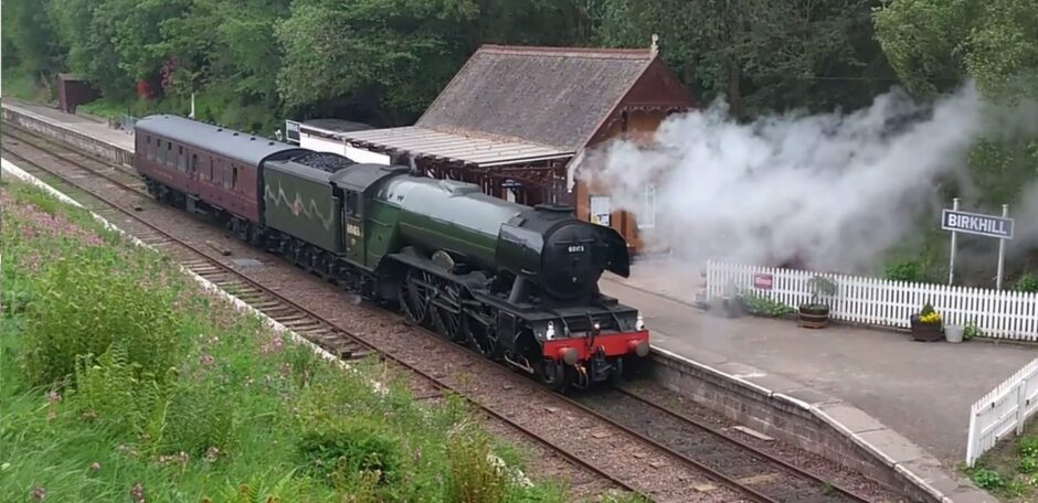 The Flying Scotsman pulls in alongside the former Monifieth Railway Station building. Image: Supplied.