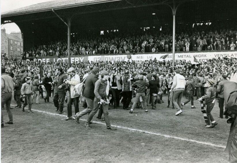 The Dens pitch was invaded by jubilant United supporters following the title victory. Image: DC Thomson.
