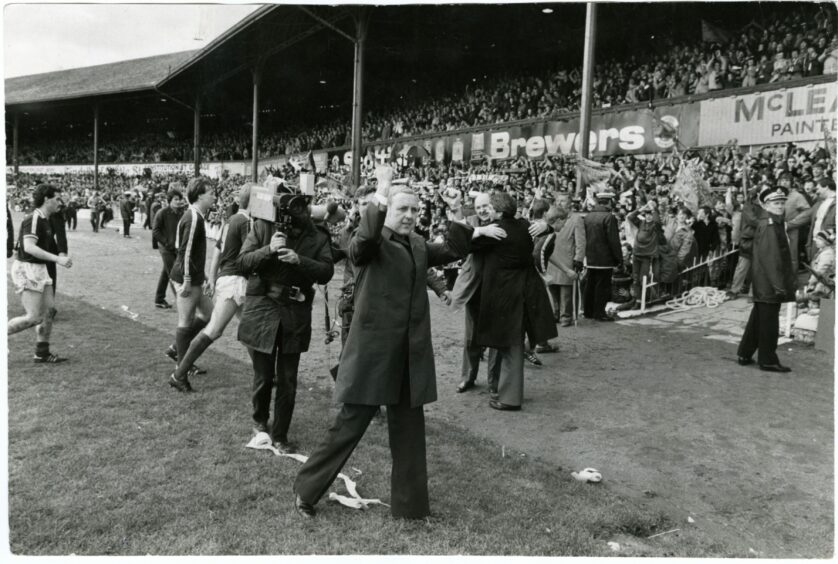 Jim McLean punches the air whilst being followed by the TV cameras. Image: DC Thomson.