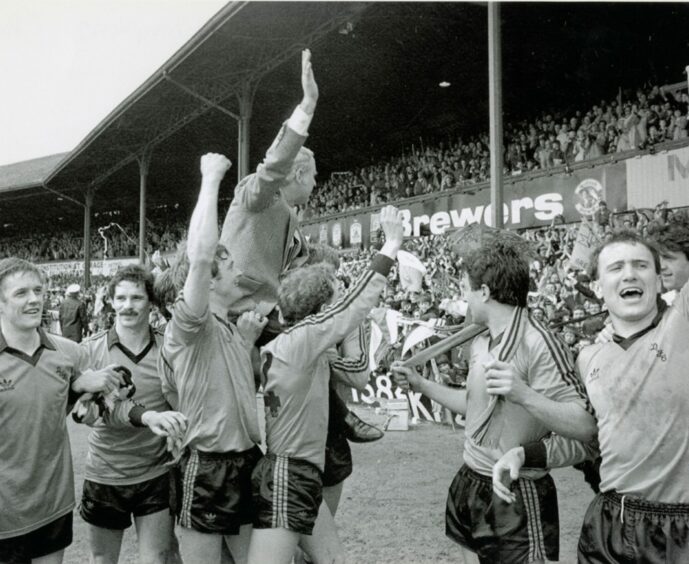 Jim McLean is raised aloft by his players to take further applause after the dust settled. Image: DC Thomson.