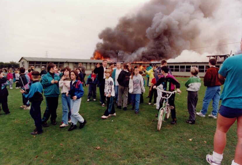 School pupils gathered to watch the science block burning in 1992. Image: DC Thomson.