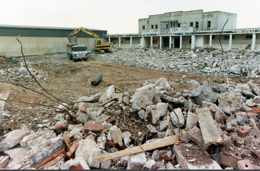Memories of the famous pool disappeared in a pile of rubble, with a digger and truck at work . Image: DC Thomson.