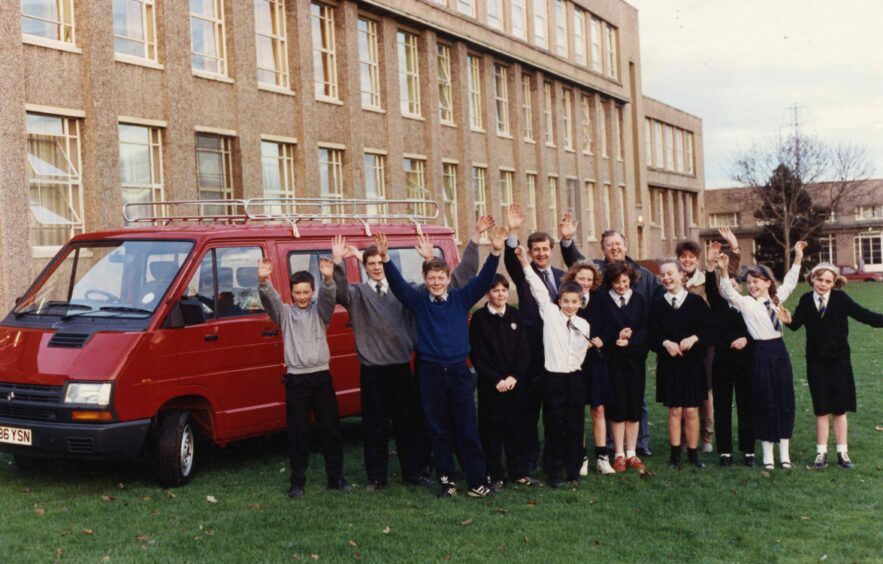 Pupils cheers as the new school minibus arrives in November 1990. Image: DC Thomson.