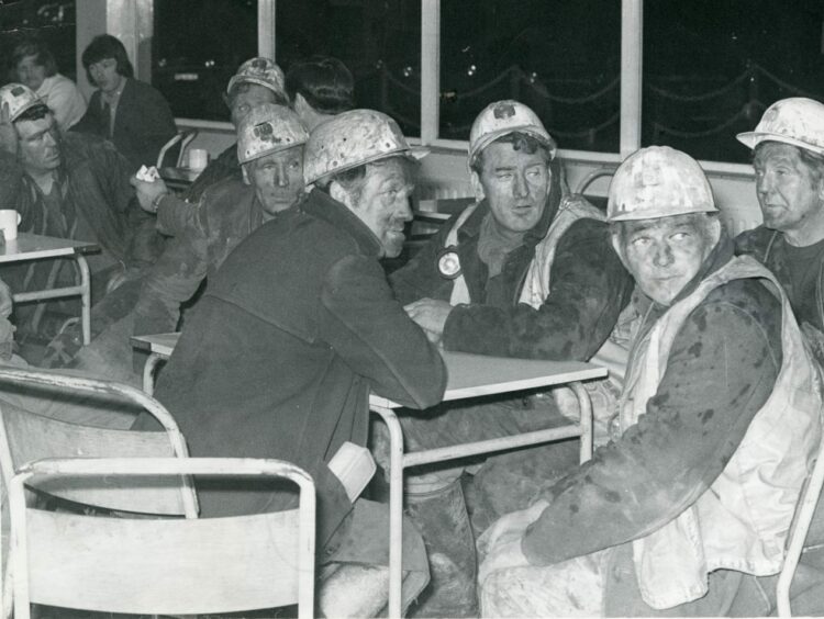 Exhausted rescue workers take a break after another shift attempting to find their workmates. Image: DC Thomson.